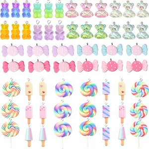 May include: A collection of assorted charms featuring gummy bears in various translucent colors, candy-shaped pieces with polka dots, and colorful swirled lollipops and popsicles. Each charm includes a small metal loop for attachment purposes.