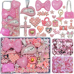 May include: A collection of pink-themed craft supplies including a phone case, various rhinestone-encrusted charms shaped like lips, bows, hearts, crosses, and a ballerina, alongside loose pink crystals and small floral embellishments for decoration.