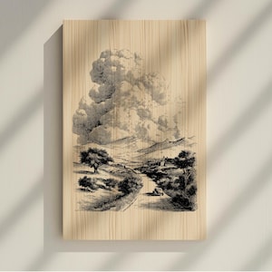May include: A black and white landscape print on a wooden panel. The artwork depicts a road winding through a valley, with trees, mountains, and a large cloud formation. A vintage car is on the road. The print has a vintage, sketched aesthetic.