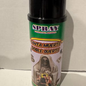 May include: A green and silver spray can with a black cap. The can features the word "SPRAY" in white, and the words "SANTA MUERTE DOBLE SUERTE" in yellow. An image of a hooded skeleton is on the can, along with images of people.