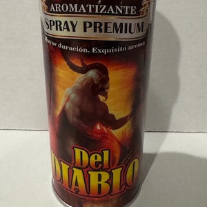 May include: A cylindrical spray bottle with a black cap and a label featuring a demonic figure. The label reads "AROMATIZANTE SPRAY PREMIUM" and "Del DIABLO". The background is a gradient of red and orange.