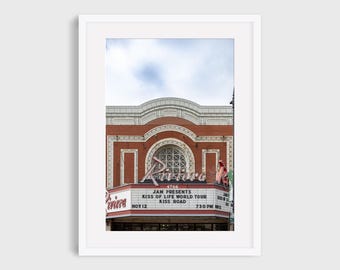 May include: A vintage red brick building with a large marquee sign advertising a concert by Kiss of Life World Tour at the Riviera Theater on November 12th at 7:30 PM.