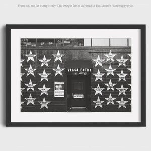 May include: Black and white framed print of the 7th St. Entry music venue. The facade features white stars with band names, and the venue's name is above the entrance. The print is a photography print.