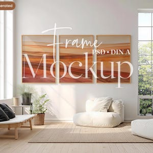 May include: Three framed art prints with abstract landscape designs in warm earth tones hang on a white wall. The frames are light-colored wood. The room includes a window, seating, and plants. The text "Frame Mockup" is overlaid on the art.