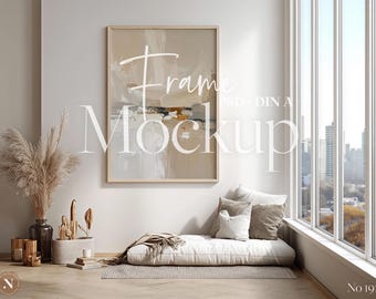 May include: A framed abstract art print in neutral tones hangs above a white daybed with pillows. The room features a large window with a city view, a vase of pampas grass, and decorative items, creating a modern, minimalist aesthetic.