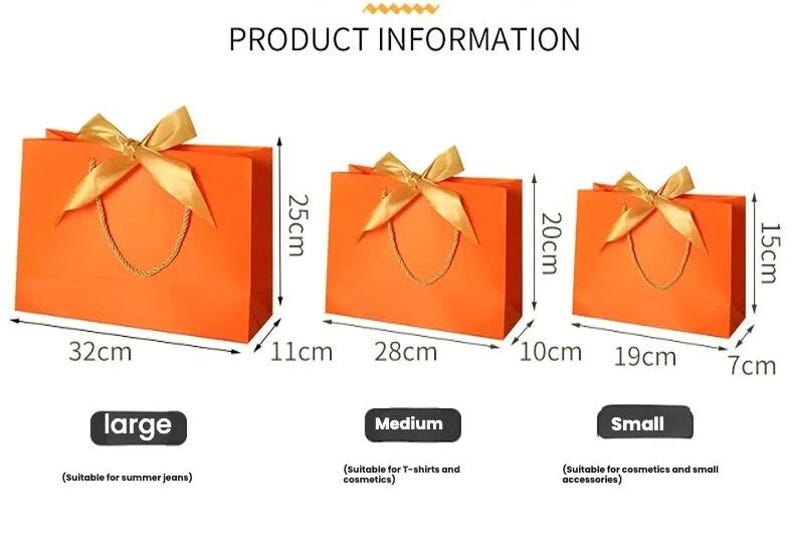 May include: Orange gift bags in three sizes: large (32cm x 25cm x 11cm), medium (28cm x 20cm x 10cm), and small (19cm x 15cm x 7cm). Each bag has a gold ribbon bow and a gold cord handle. Product information is displayed.