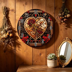 May include: A round wall clock with a black face featuring a heart-shaped stained glass design with red roses. The clock has gold hands and numbers, and is mounted on a wooden wall. The clock measures approximately 12 inches in diameter.