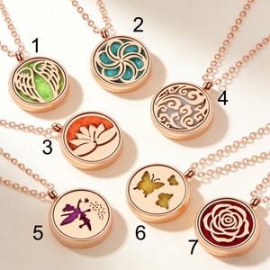May include: Rose gold pendant necklaces with diverse designs. The pendants have intricate cut-out patterns and coloured inserts, including wings, a flower, butterflies, and a fairy. Each necklace has a delicate chain.