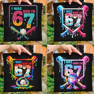 May include: Black tote bag with a colorful baseball-themed graphic. The design features the text "I WAS NOW I'M 67" with a baseball, bats, and dripping paint effects. The numbers are decorated with a donut and a popsicle.