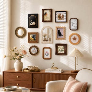 May include: A gallery wall arrangement featuring various rectangular, arched, and circular frames in wood, gold, and dark tones. The collection includes art prints of a swan, a cat, flowers, and a leaf, alongside mirrors and personal photographs.