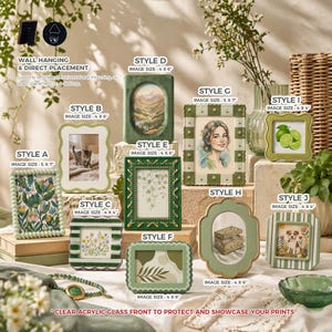 May include: A collection of decorative picture frames in various styles and sizes, with green and white color schemes. Some frames feature floral, landscape, and portrait images. The frames are designed for wall hanging or desktop display, with clear acrylic glass fronts.