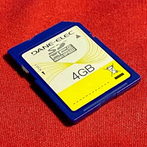 May include: Blue SD card with the text "DANE-ELEC SEC HIGH SPEED" and "4GB" printed on it.