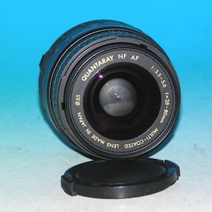 May include: Black Quantaray NF AF camera lens with a lens cap. The lens has the following text: 1:3.5-5.6, f=28-80mm, Multi-Coated Lens Made in Japan, and 055.