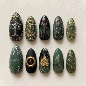 May include: A set of ten almond-shaped press-on nails featuring intricate designs in shades of black, forest green, and metallic gold. The artwork includes a white tree, a horse, a circular door, elvish script, a gold leaf, and mountain peaks.