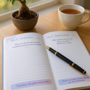 May include: An open journal with lined pages, a black pen, and a cup of tea sit on a wooden table. A small bonsai tree in a brown pot is also on the table. The journal pages read "Day 5 - Awareness" and "Day 6 - Relationships".