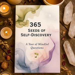 May include: A book titled "365 Seeds of Self-Discovery" with watercolor-style artwork. The image includes lit candles, crystals, and a cup of tea, creating a serene, mindful theme. The book's subtitle reads "A Year of Mindful Questions."
