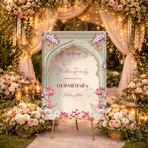 May include: A wedding welcome sign with a floral design. The sign has a light green background with floral accents and gold trim. The text reads "Sandhu Family Welcomes You To The Gurmehar's Wedding Week."