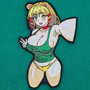May include: Embroidered patch featuring an anime-style character with blonde hair, wearing a green tank top and yellow bikini bottoms. The character has a red choker and is outlined in black. The patch is designed for application on clothing or accessories.