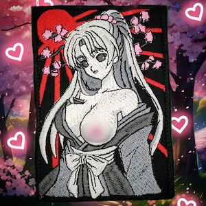May include: Embroidered patch featuring an anime-style woman with long white hair, wearing a gray kimono with a large bow. The design includes a red sun, pink cherry blossoms, and a black border. The patch is rectangular.