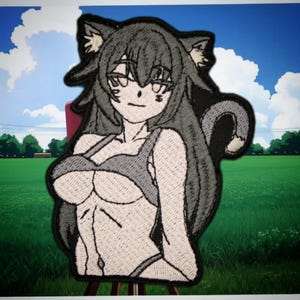 May include: Embroidered patch featuring a stylized anime-style character with cat ears and a tail. The character is depicted in shades of gray and white, wearing a bikini top and bottoms. The patch has a black border.