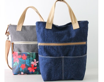 Pode incluir: Duas bolsas tote, uma de sarja jeans azul e outra cinza com estampa floral, ambas com alças de couro marrom e bolsos com zíper. O texto "RUTH TOTE BAG" e "Digital PDF Sewing Pattern" está na parte superior da imagem. O texto "Story Quilt Etsy Shop" está na parte inferior da imagem.