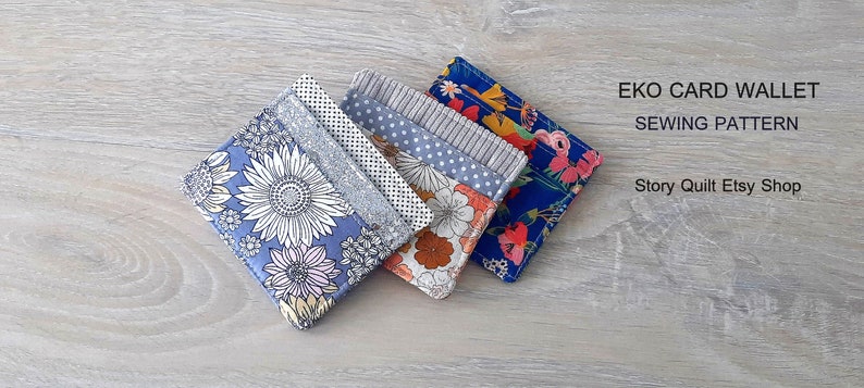 May include: Four different fabric card wallets with floral patterns. The wallets are stacked on top of each other. The text "EKO CARD WALLET SEWING PATTERN Story Quilt Etsy Shop" is visible in the top right corner of the image.