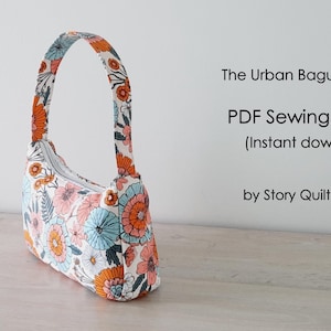 May include: A white fabric bag with a floral print in shades of orange, blue, and pink. The bag has a single strap and a zipper closure. The text "The Urban Baguette Bag" and "PDF Sewing Pattern (Instant download)" is visible on a white background. The text "by Story Quilt Etsy Shop" is also visible.