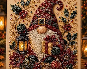 May include: A square diamond painting featuring a gnome wearing a red hat with a belt buckle, a long white beard, and a round nose. The gnome holds a gold gift box and a lit lantern, surrounded by holly leaves, red berries, and ornaments.