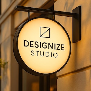 May include: A circular, illuminated sign displaying "DESIGNIZE STUDIO" in black lettering. The sign is mounted on a black metal bracket against a beige building exterior. A square and diagonal line graphic is above the text.