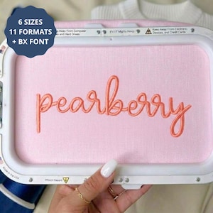 May include: A white plastic embroidery hoop holding light pink fabric with the word pearberry embroidered in coral thread. A dark blue circular graphic in the top left corner displays the text 6 SIZES 11 FORMATS + BX FONT in white.