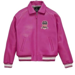 May include: A bright fuchsia leather jacket in a bomber style. It has a zip-up front, a collared neckline, and ribbed cuffs and hem with white stripes. An embroidered patch with the text "AVIREX" and a patriotic design is on the chest.