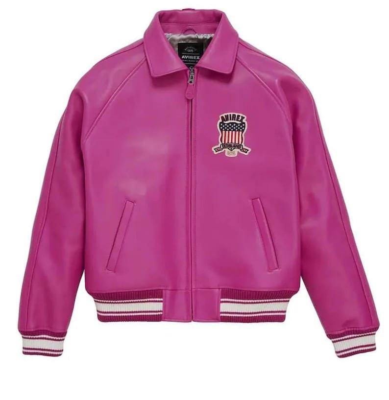 May include: A bright fuchsia leather jacket in a bomber style. It has a zip-up front, a collared neckline, and ribbed cuffs and hem with white stripes. An embroidered patch with the text "AVIREX" and a patriotic design is on the chest.