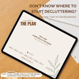 May include: A digital tablet displaying an interactive PDF titled The 7-Day Home Declutter Reset. The screen features the text Don't know where to start decluttering? Your next 7 days are already planned, Just follow the plan, and Day 1 through Day 7.