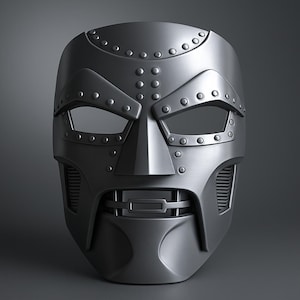 May include: A metallic gray mask with a distinctive design, featuring riveted details and eye openings. The mask has a prominent nose and mouth area, with a stylized, angular shape. The overall aesthetic suggests a futuristic or superhero theme.