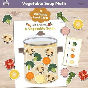May include: A printable educational activity titled Vegetable Soup Math featuring a large cooking pot illustration, cut-out vegetable shapes including mushrooms, broccoli, carrots, corn, onions, and peppers, and a medium difficulty level card.