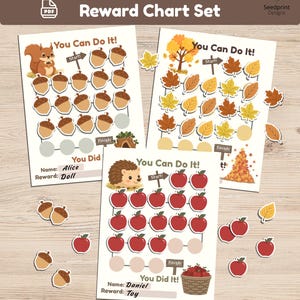 May include: A set of three printable reward charts featuring a squirrel with acorns, autumn leaves, and a hedgehog with red apples. Each chart includes the text You Can Do It, a Start sign, a Finish sign, and spaces for a name and reward. Loose stickers of acorns, leaves, and apples are scattered around the charts.