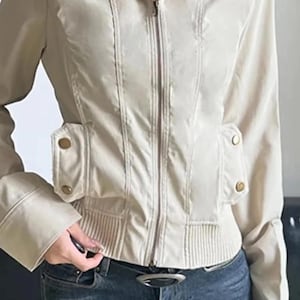 Women's Slim Fit Jacket | Casual Zipper Coats | Solid Streetwear Winter Fashion

Women wearing a slim-fit zippered jacket with long sleeves and a structured shape, styled with low-rise jeans for a modern streetwear look.