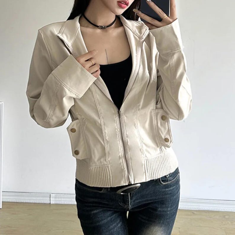 Women's Slim Fit Jacket | Casual Zipper Coats | Solid Streetwear Winter Fashion

Women wearing a slim-fit zippered jacket with long sleeves and a structured shape, styled with low-rise jeans for a modern streetwear look.
