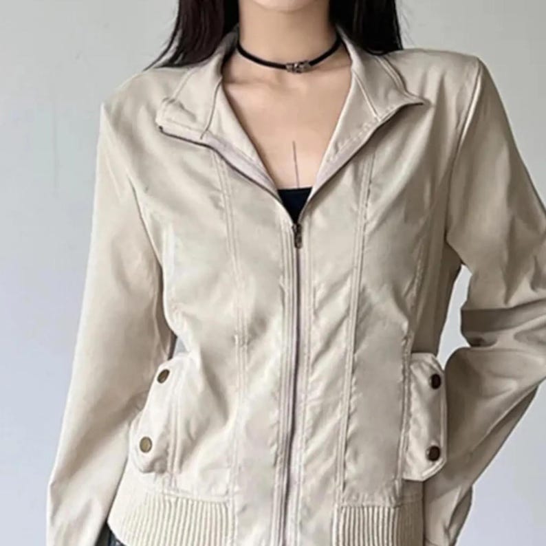 Women's Slim Fit Jacket | Casual Zipper Coats | Solid Streetwear Winter Fashion

Women wearing a slim-fit zippered jacket with long sleeves and a structured shape, styled with low-rise jeans for a modern streetwear look.