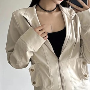 Women's Slim Fit Jacket | Casual Zipper Coats | Solid Streetwear Winter Fashion

Women wearing a slim-fit zippered jacket with long sleeves and a structured shape, styled with low-rise jeans for a modern streetwear look.