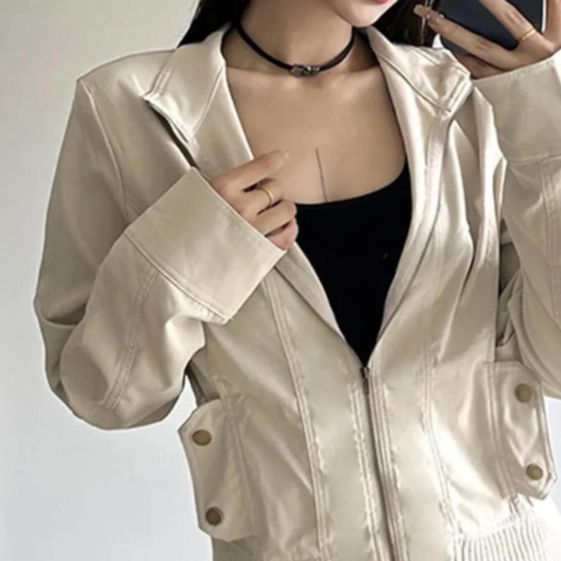 Women's Slim Fit Jacket | Casual Zipper Coats | Solid Streetwear Winter Fashion

Women wearing a slim-fit zippered jacket with long sleeves and a structured shape, styled with low-rise jeans for a modern streetwear look.
