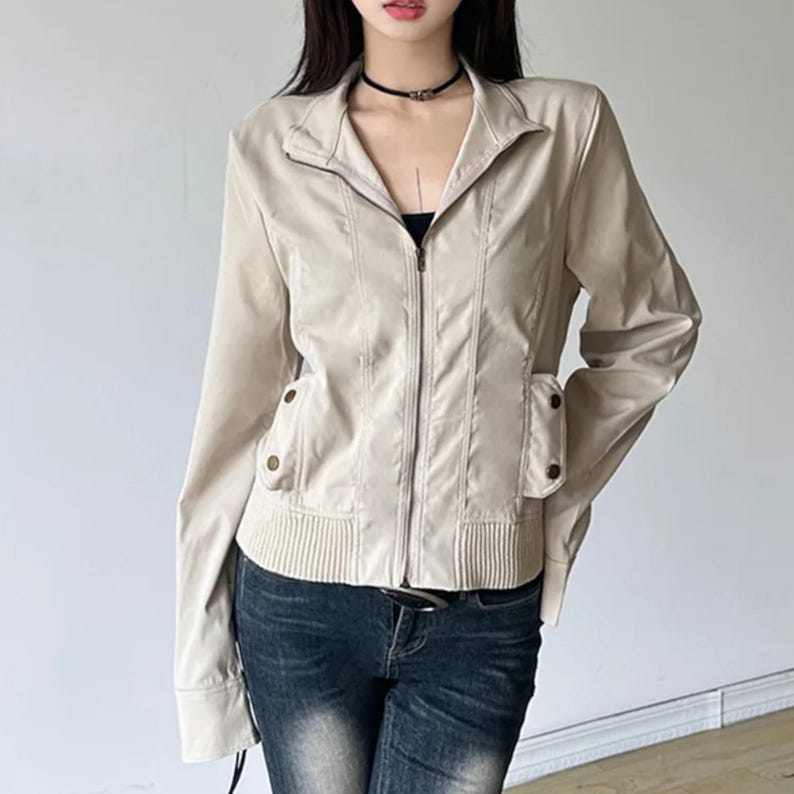 Women's Slim Fit Jacket | Casual Zipper Coats | Solid Streetwear Winter Fashion

Women wearing a slim-fit zippered jacket with long sleeves and a structured shape, styled with low-rise jeans for a modern streetwear look.