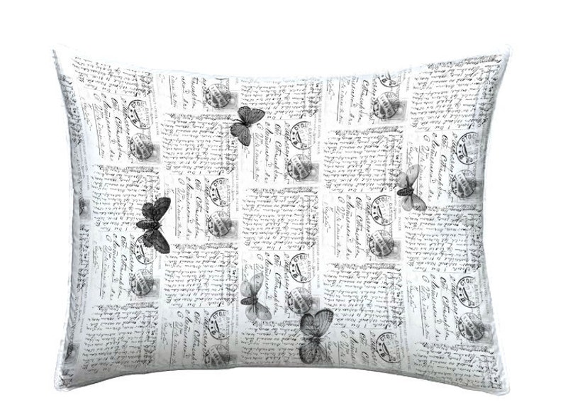 May include: Rectangular decorative pillow with a vintage postcard design. The white pillow features a repeating pattern of old postage stamps, handwritten script, and grayscale butterfly illustrations. A charming accent for any room.