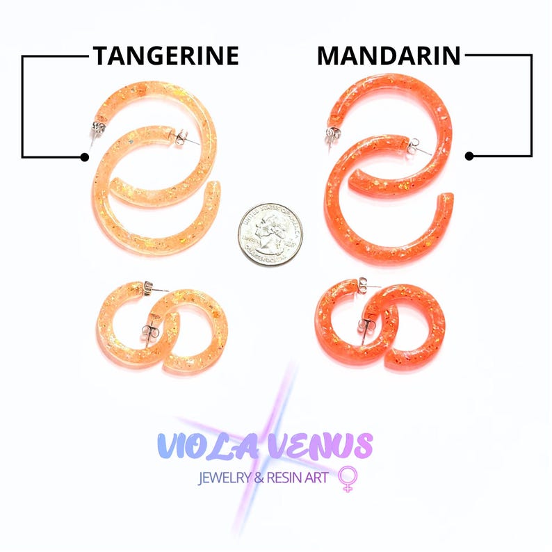 May include: Two sets of hoop earrings in tangerine and mandarin orange resin with gold-toned glitter flecks. A US quarter coin is placed between the sets for scale. The text TANGERINE and MANDARIN labels the colors, with VIOLA VENUS JEWELRY & RESIN ART below.