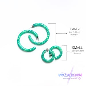 May include: Two pairs of bright green hoop earrings with embedded glitter, labeled as large with a 2-inch diameter and small with a 1.25-inch diameter. The text Viola Venus Jewelry & Resin Art is visible in the bottom right corner of the image.