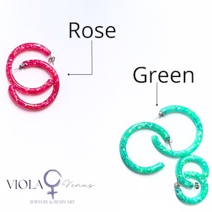 May include: Two pairs of circular hoop earrings with a glittery finish. One pair is bright rose pink, and the other is vibrant green. The text Rose and Green labels each pair, and the logo VIOLA Venus JEWELRY & RESIN ART is at the bottom.