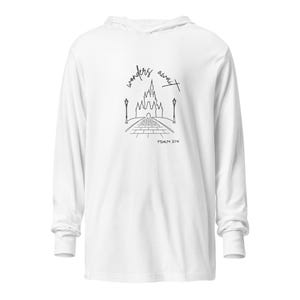 May include: White long-sleeve hooded shirt with a black line drawing of a castle, street lamps, and the text "wonders await" and "Psalm 374". The shirt has a classic fit and long sleeves.