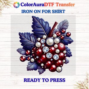 May include: A digital transfer design featuring a cluster of red orbs, pearls, and sparkling gems, surrounded by blue leaves. The design includes the text "ColorAuraDTF Transfer IRON ON FOR SHIRT READY TO PRESS".