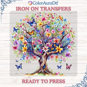 May include: A colorful iron-on transfer featuring a tree with vibrant flowers and butterflies. The design includes the text "IRON ON TRANSFERS" at the top and "READY TO PRESS" at the bottom. The tree's branches are filled with pink, yellow, and blue flowers.
