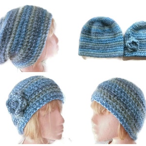 May include: Four blue and gray crocheted hats with a flower detail. Two hats are shown on a mannequin head and two hats are shown flat.